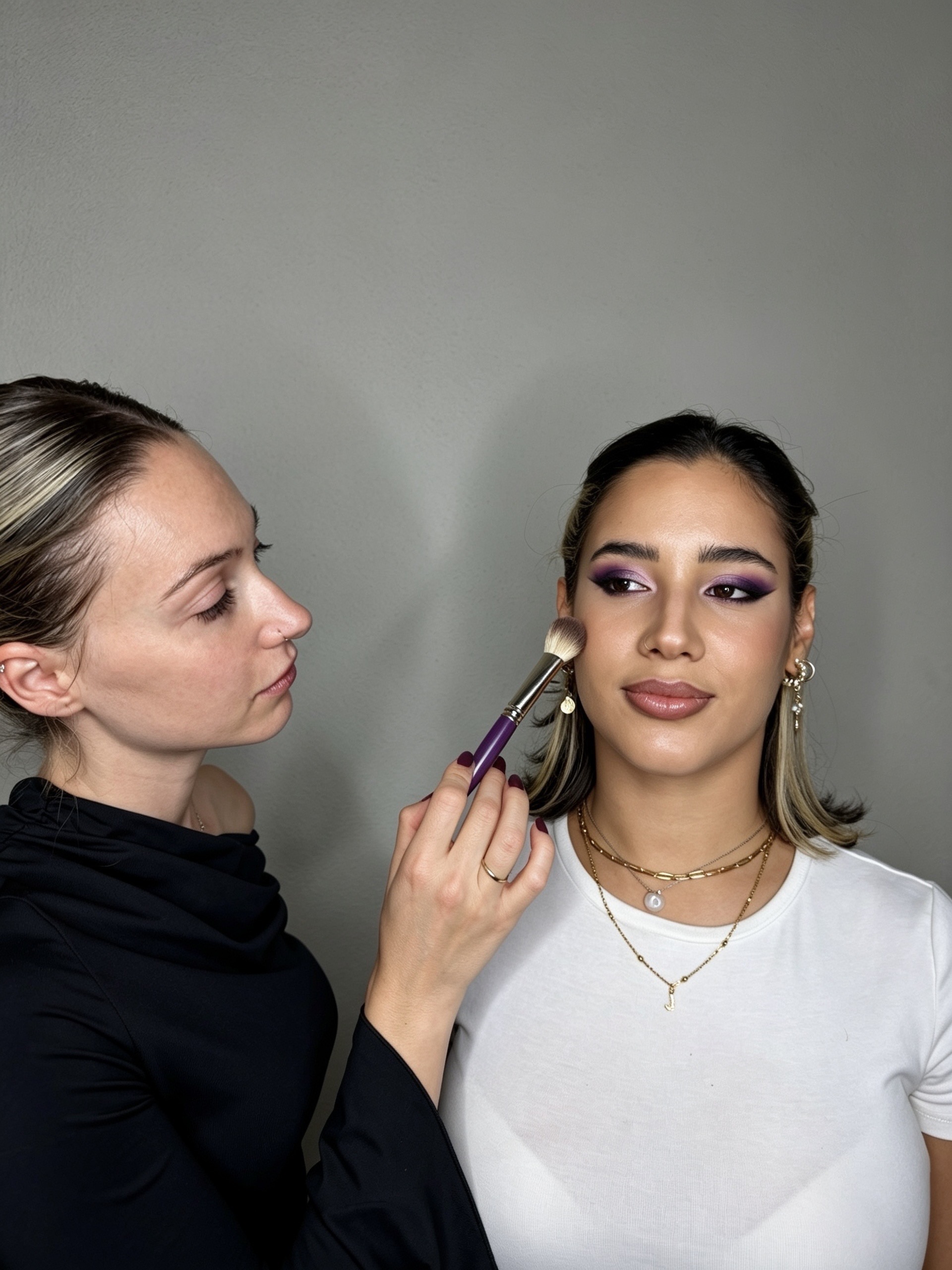 Purple smokey eye glam makeup application on set